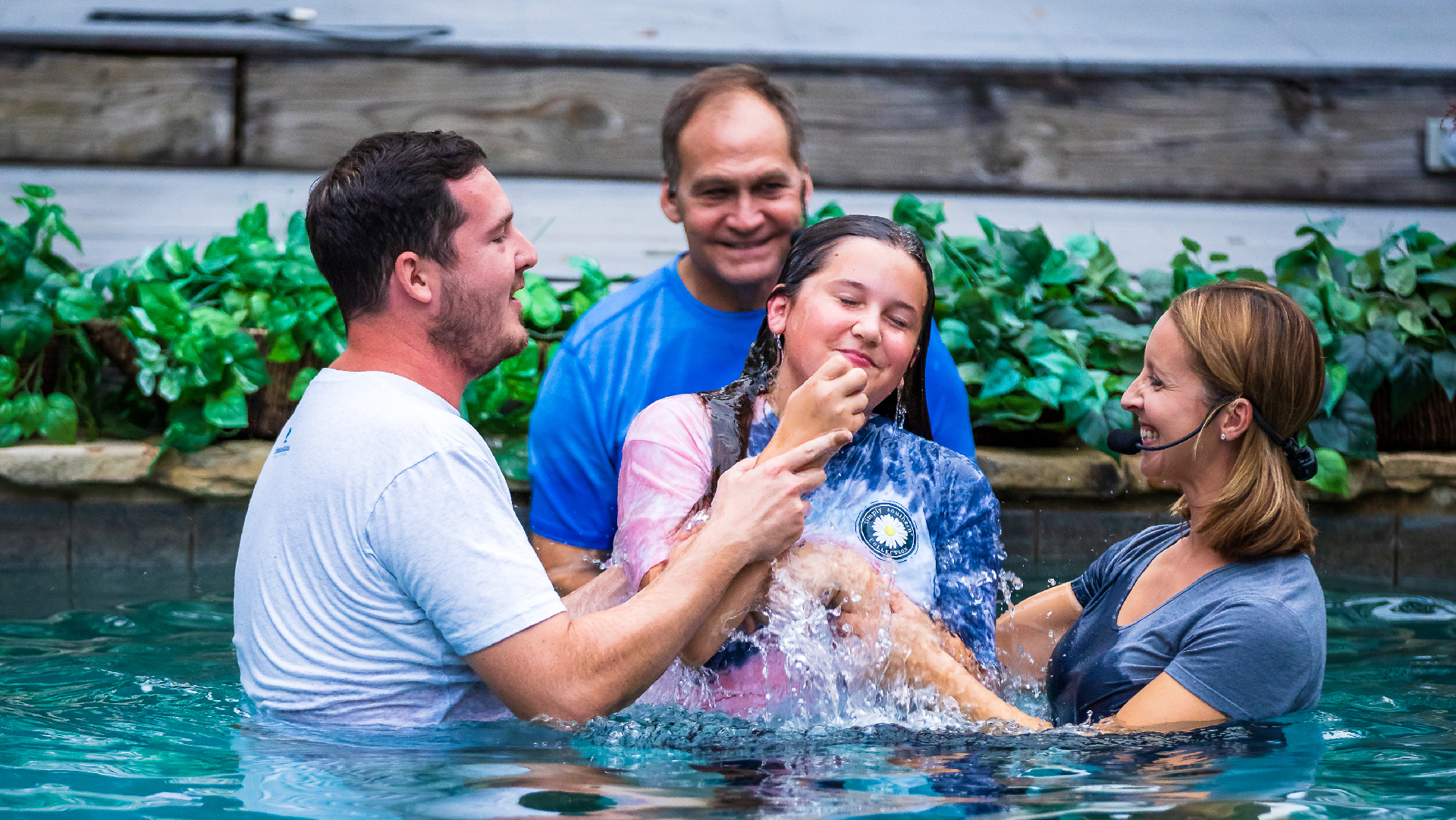 Young teens smiling as they're being baptized at Brookwood Church