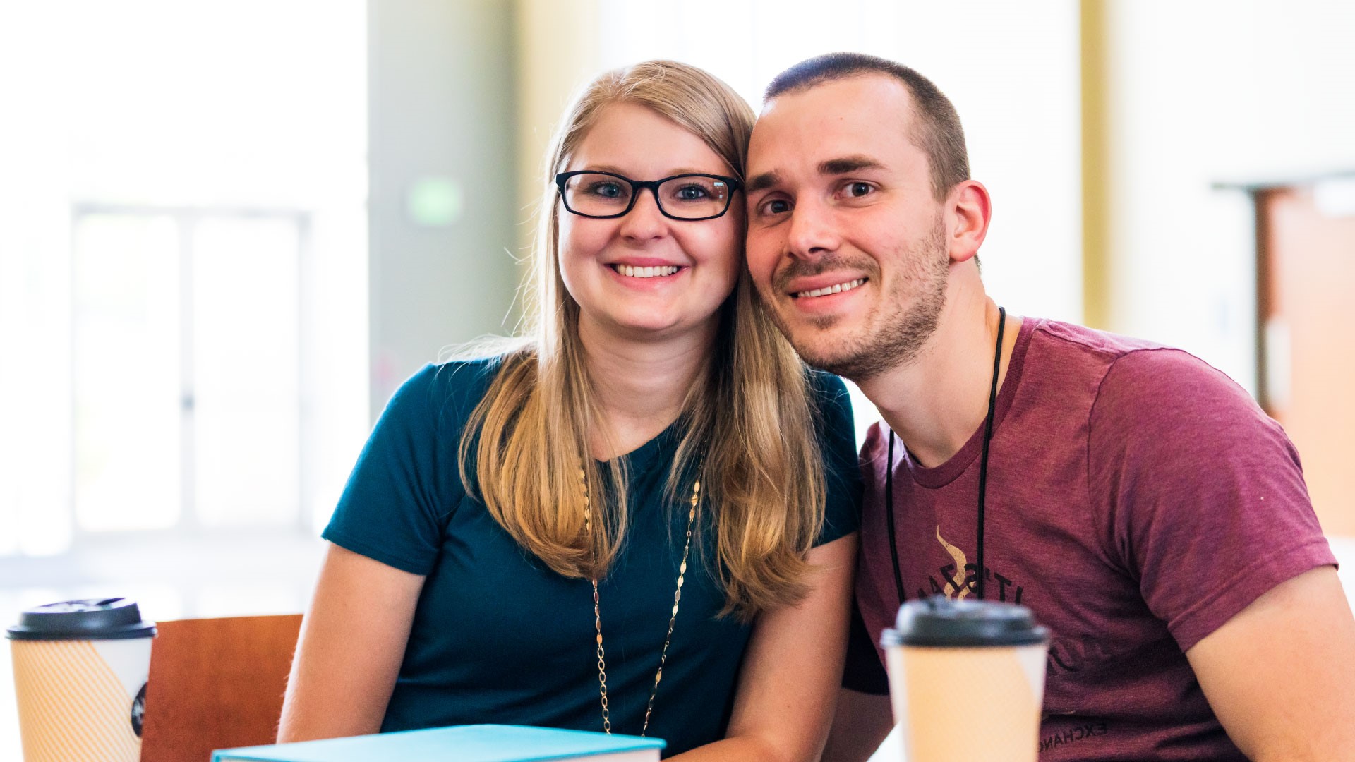 A married couple sitting close and smiling at Brookwood Church